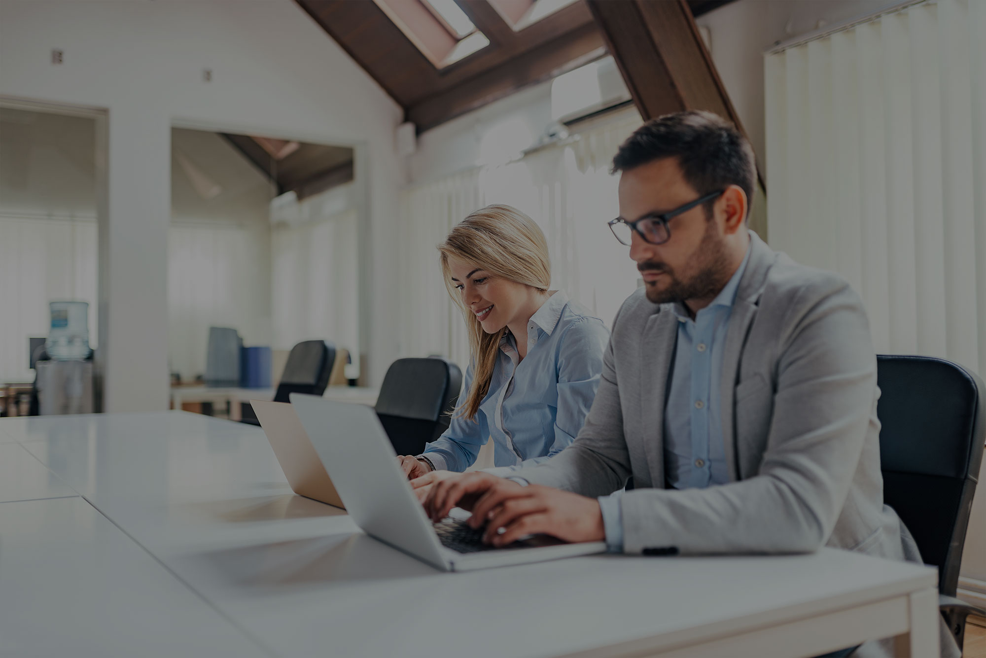 stock-photo-two-people-working-at-bright-modern-office-1116615506